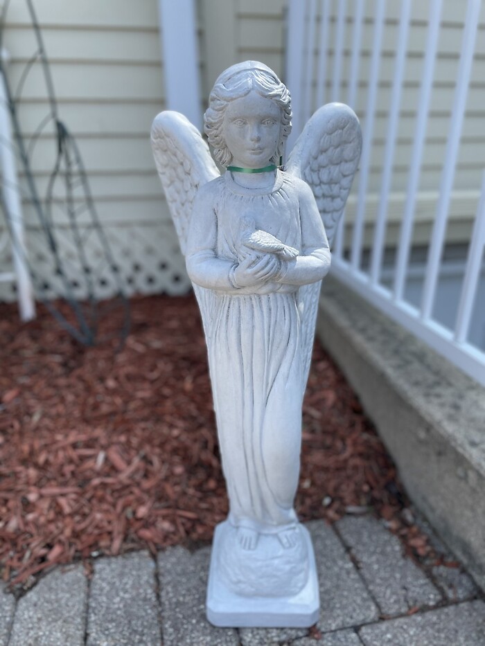 Tall angel holding a bird